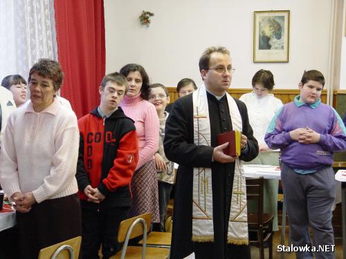 Ks. Stanisław Rząsa prowadzi modlitwę podczas spotkania w sali katechetycznej parafii św. Floriana